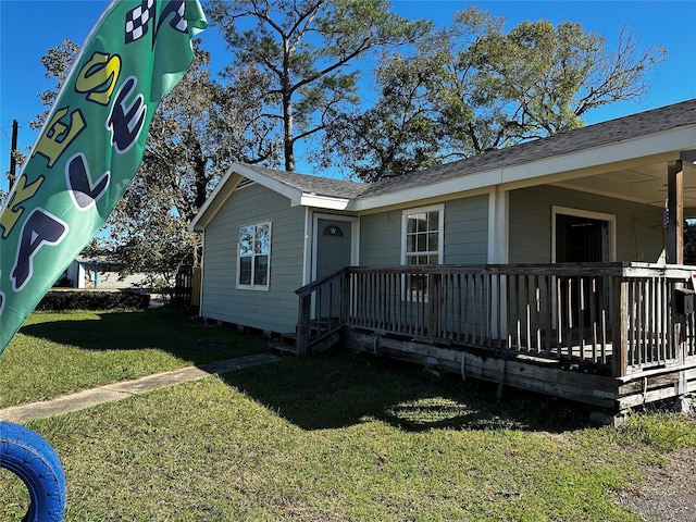 view of side of home with a lawn