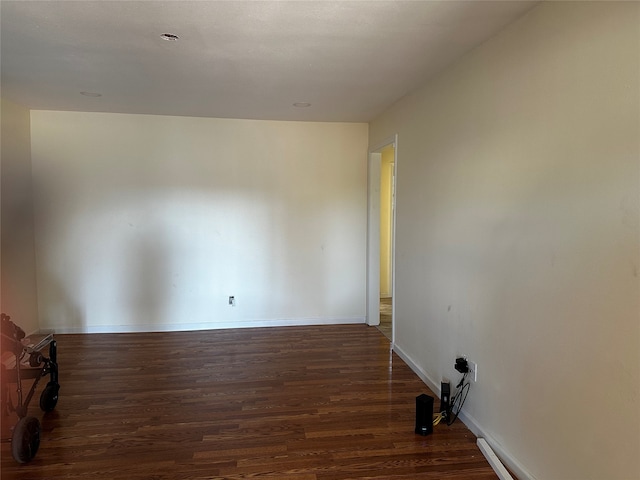 unfurnished room featuring dark wood-type flooring