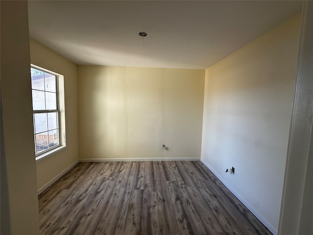 spare room with dark wood-type flooring