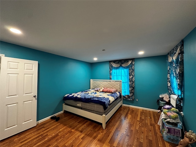 bedroom featuring dark hardwood / wood-style flooring