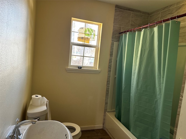 full bathroom featuring shower / bath combination with curtain, toilet, and sink