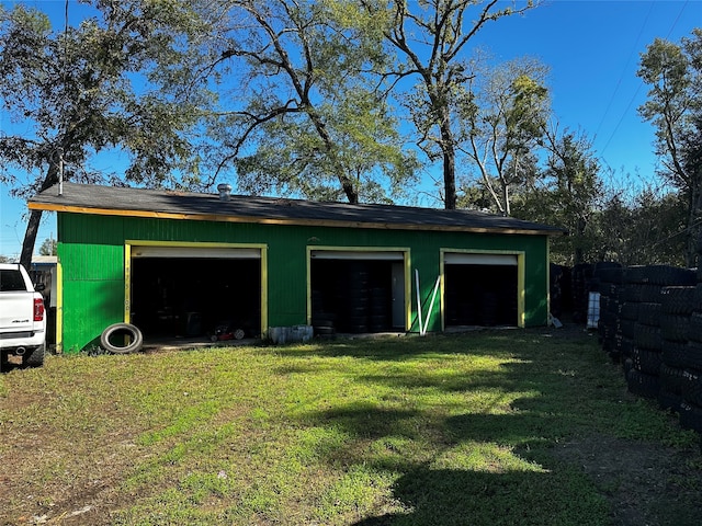 garage featuring a lawn