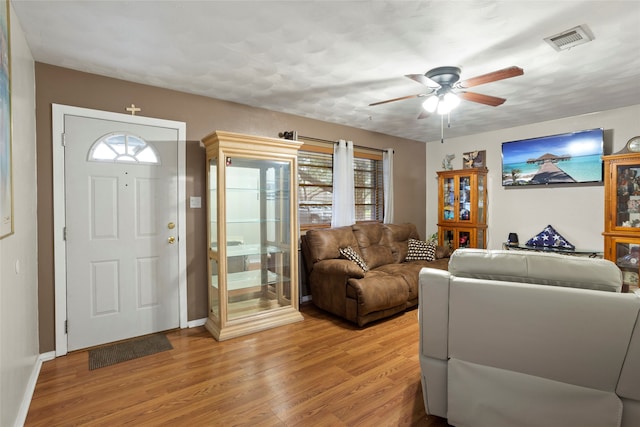 living room with ceiling fan and hardwood / wood-style flooring