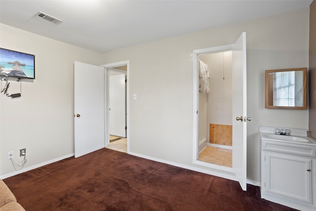 unfurnished bedroom featuring light colored carpet and sink