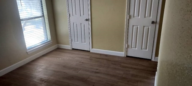 unfurnished bedroom featuring dark hardwood / wood-style flooring