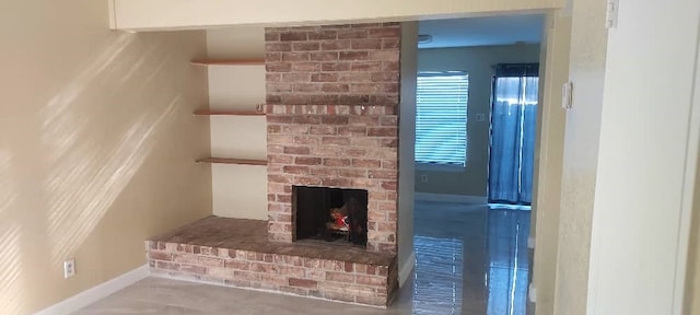 unfurnished living room with a brick fireplace