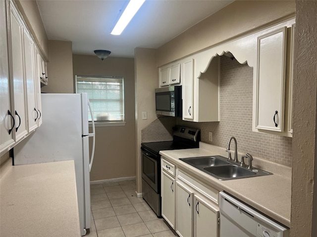 kitchen with tasteful backsplash, stainless steel appliances, sink, white cabinetry, and light tile patterned flooring