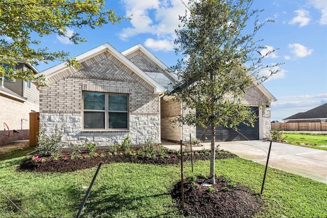 view of front of property with a garage and a front lawn