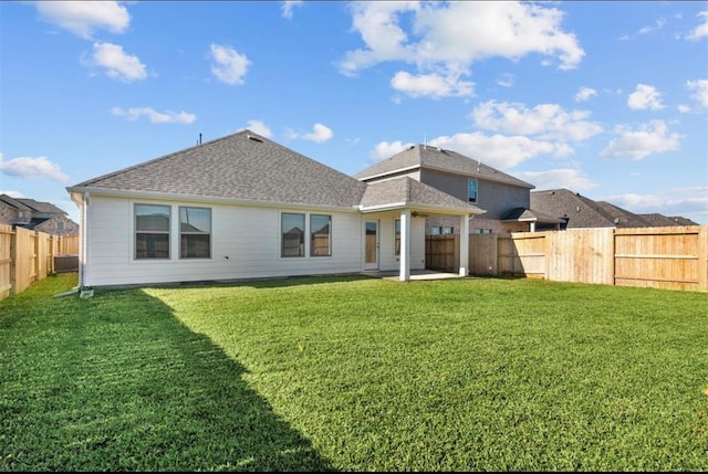 back of property featuring a patio and a lawn