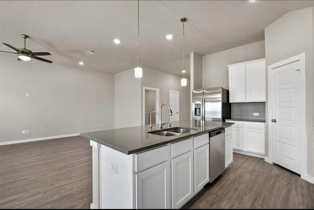 kitchen with a center island with sink, white cabinetry, sink, and appliances with stainless steel finishes