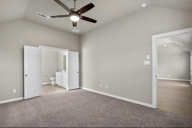 unfurnished bedroom with carpet flooring, ensuite bath, ceiling fan, and lofted ceiling