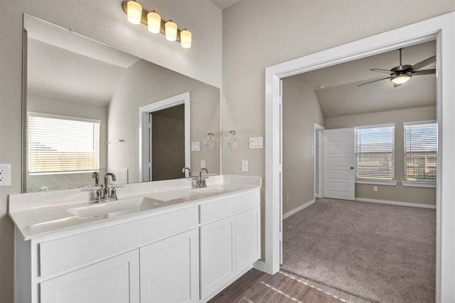 bathroom with vanity, hardwood / wood-style flooring, ceiling fan, and lofted ceiling