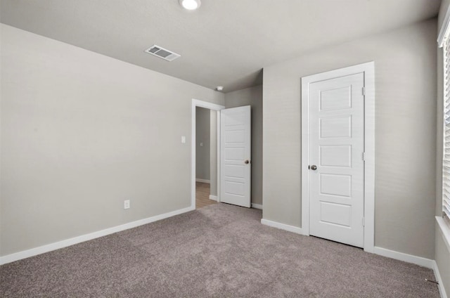 unfurnished bedroom with light carpet