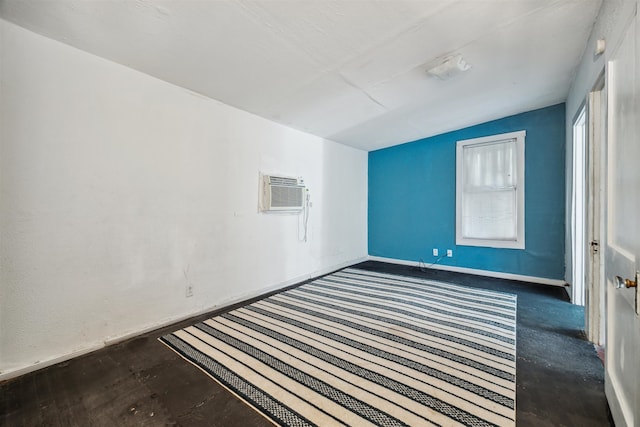 empty room with vaulted ceiling and a wall mounted air conditioner