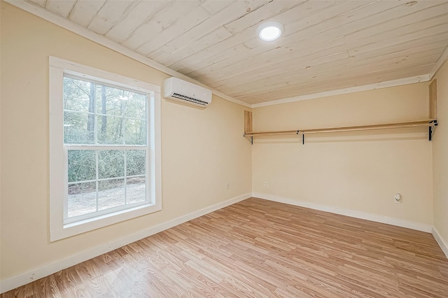 unfurnished room featuring a wall mounted air conditioner, wood ceiling, crown molding, and light hardwood / wood-style flooring