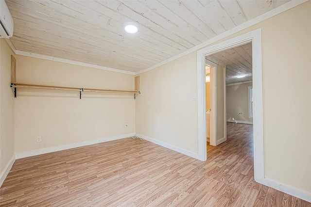 unfurnished room with a wall mounted AC, ornamental molding, wooden ceiling, and light wood-type flooring