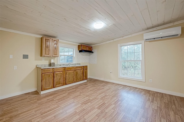 kitchen with an AC wall unit, crown molding, wooden ceiling, and light hardwood / wood-style floors