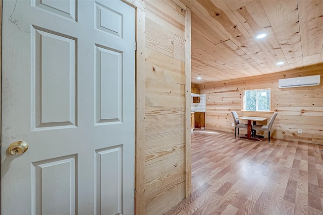 bonus room with light hardwood / wood-style flooring, wood ceiling, wooden walls, and a wall unit AC