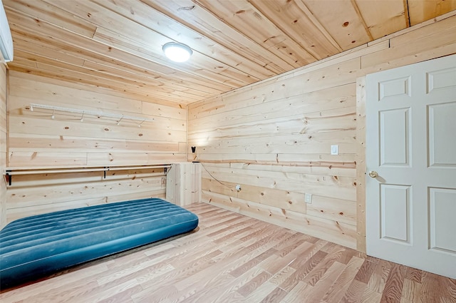 unfurnished bedroom with hardwood / wood-style flooring, wooden walls, and wood ceiling