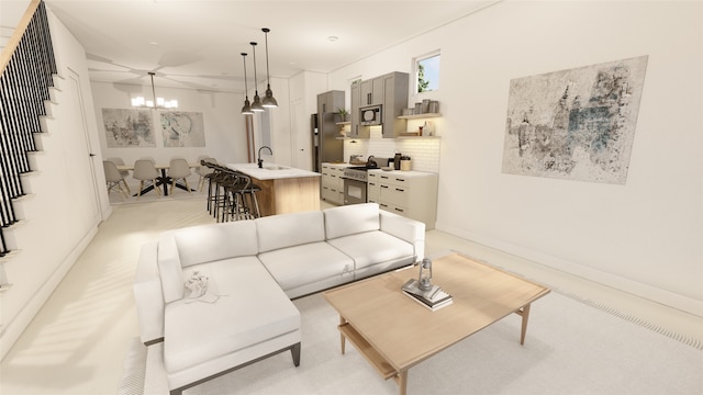 living room with sink and a chandelier