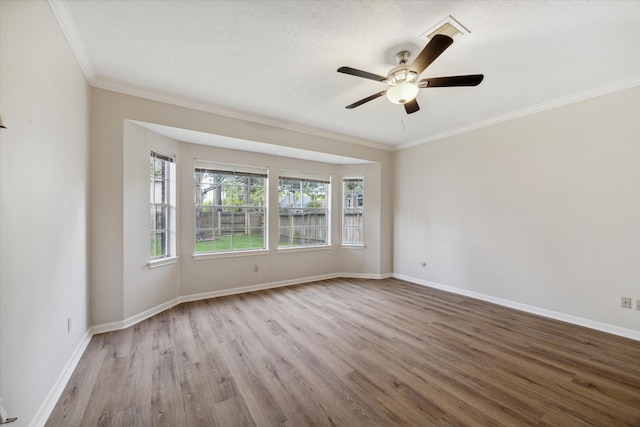 unfurnished room featuring a textured ceiling, light hardwood / wood-style flooring, ceiling fan, and crown molding