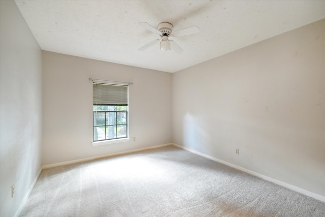 empty room featuring light colored carpet and ceiling fan