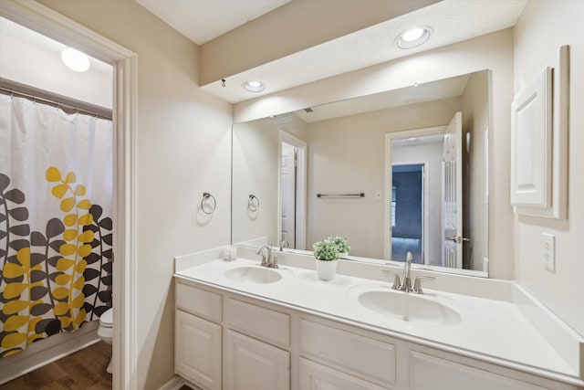 bathroom with vanity, toilet, wood-type flooring, and walk in shower