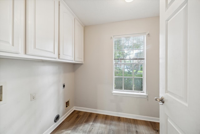 laundry room featuring cabinets, light wood-type flooring, and electric dryer hookup