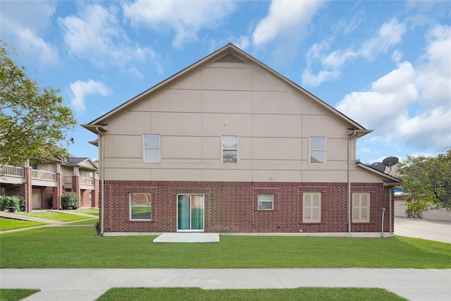 view of side of home with a yard