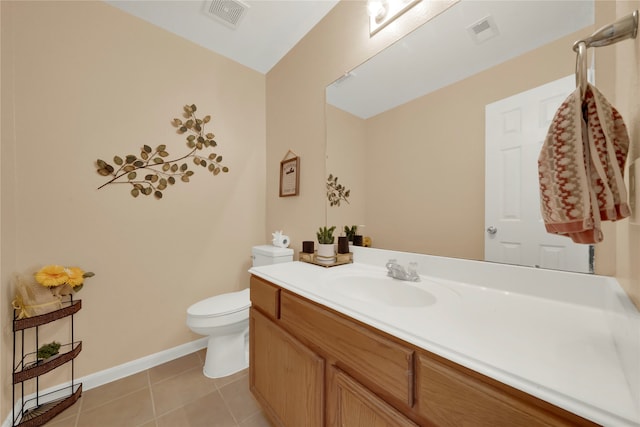 bathroom with tile patterned floors, vanity, and toilet