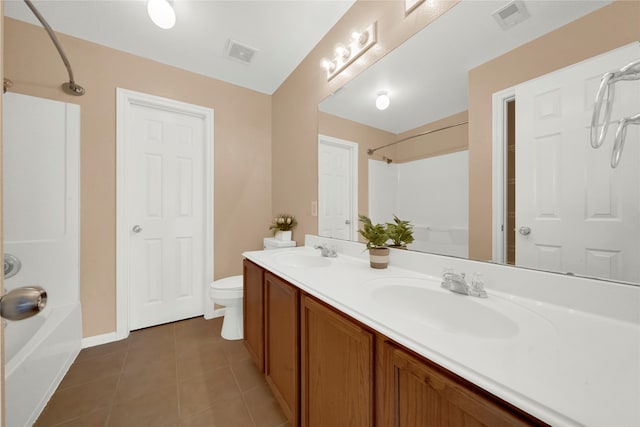 full bathroom featuring tile patterned floors, vanity, toilet, and shower / washtub combination