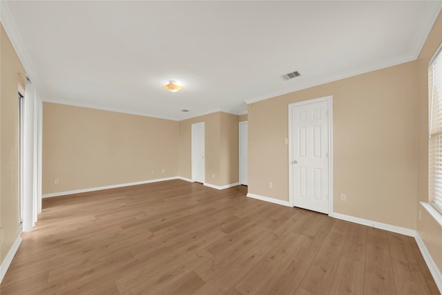 unfurnished room featuring wood-type flooring and ornamental molding