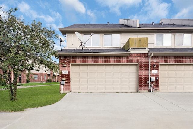 view of front of property with a garage and a front yard