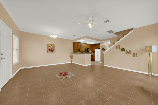 unfurnished living room with dark tile patterned flooring, ceiling fan with notable chandelier, and ornamental molding