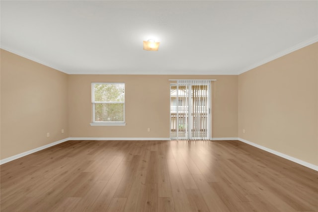 unfurnished room featuring light wood-type flooring and crown molding