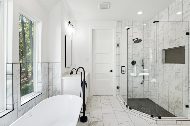 bathroom featuring plus walk in shower and vanity