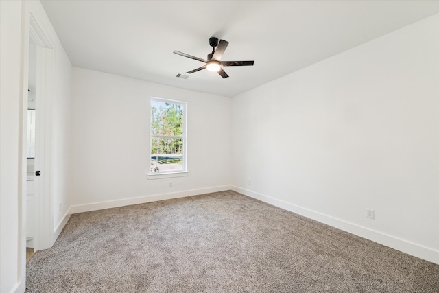 carpeted empty room featuring ceiling fan