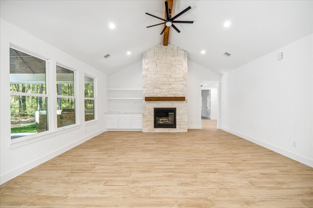 unfurnished living room featuring light wood-type flooring, ceiling fan, beam ceiling, high vaulted ceiling, and a fireplace