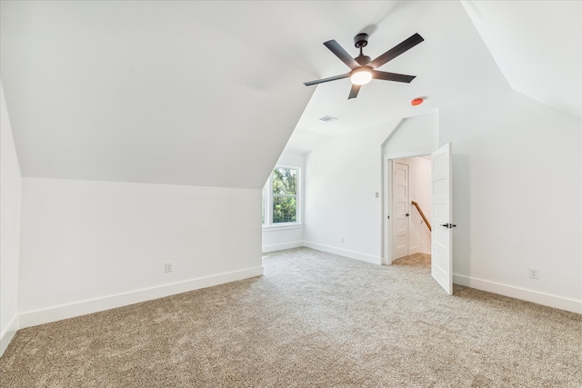 additional living space with light carpet, ceiling fan, and lofted ceiling