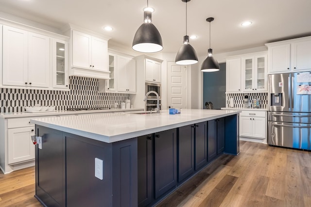 kitchen featuring white cabinets, pendant lighting, and stainless steel refrigerator with ice dispenser