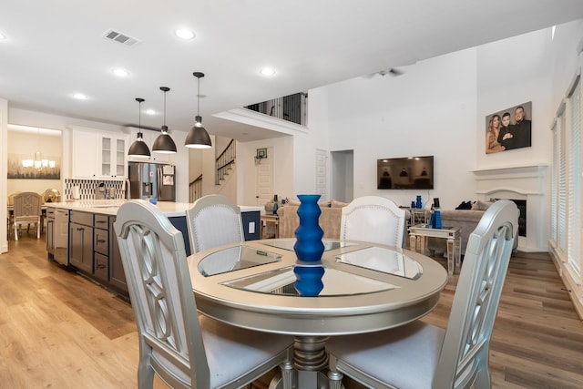 dining space featuring light hardwood / wood-style floors and an inviting chandelier