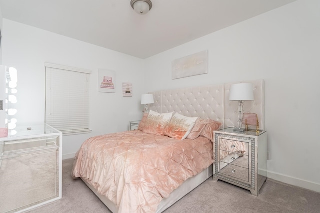 bedroom featuring light carpet