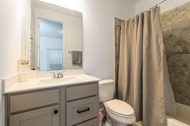 full bathroom featuring shower / bath combination with curtain, vanity, and toilet