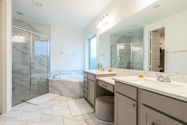 bathroom with vanity and shower with separate bathtub