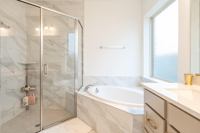 bathroom featuring vanity and independent shower and bath