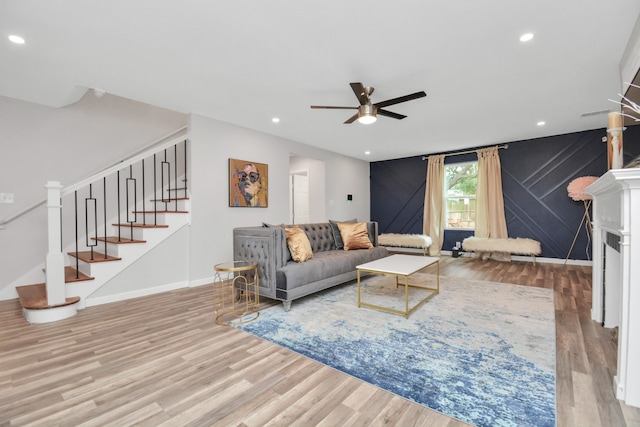 living room featuring ceiling fan and light hardwood / wood-style flooring