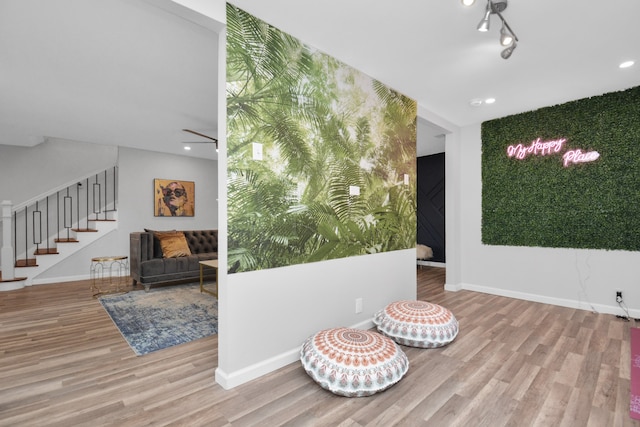 living area with ceiling fan and light wood-type flooring