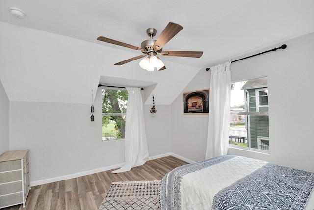 bedroom featuring ceiling fan, wood-type flooring, and vaulted ceiling