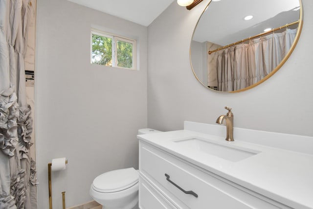 bathroom featuring vanity, a shower with shower curtain, and toilet