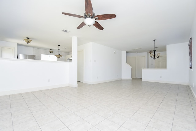 unfurnished living room featuring light tile patterned floors and ceiling fan with notable chandelier